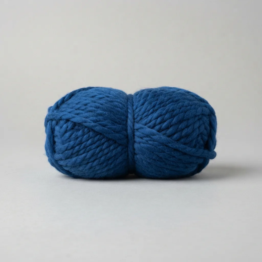 A skein of Loops & Threads Charisma bulky weight yarn in a rich blue color.